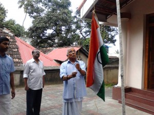 P Parameshwaran hoisting National Flag