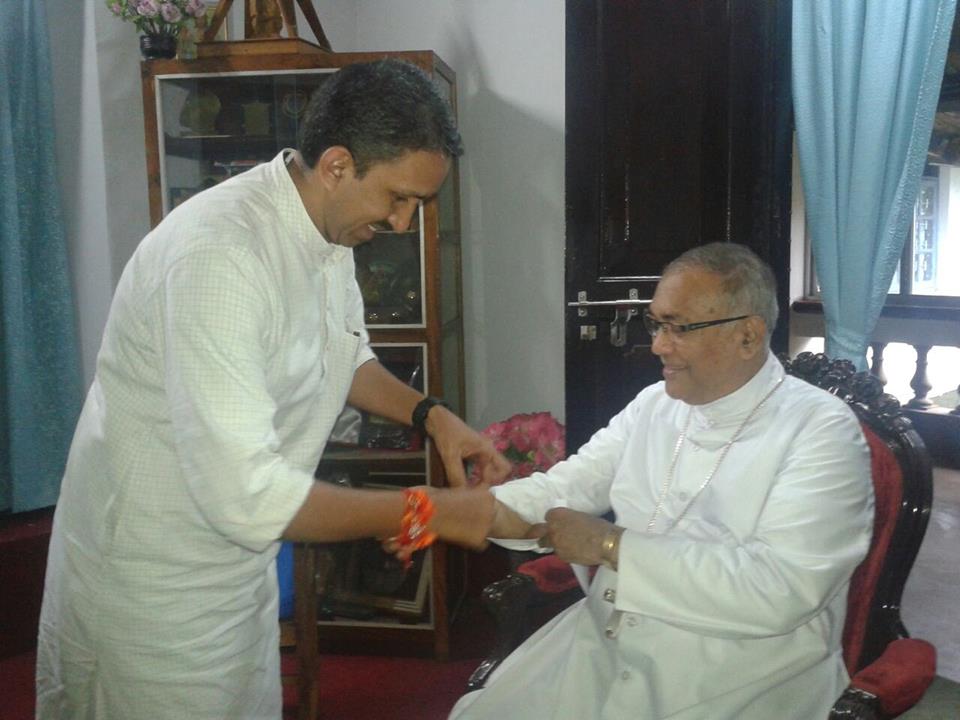 RSS Sah-Vibhag Pracharak of Mangalore, Pradeep ties Rakhi to Bishop of Mangalore, celebrating Raksha Bandhan Aug 10-2014